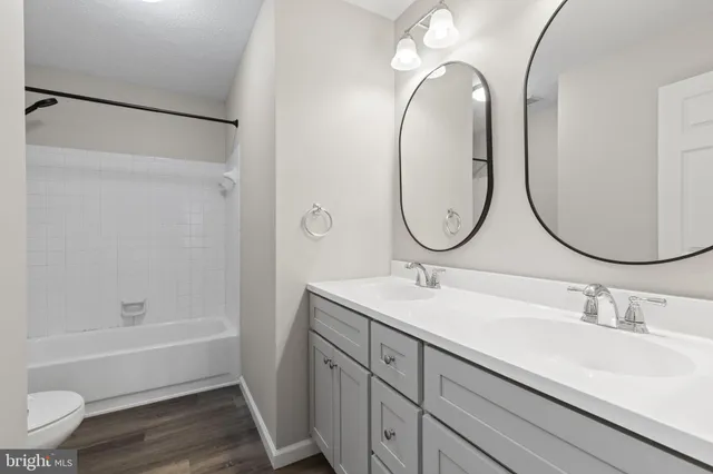 a bathroom with a bath tub with a toilet and a shower