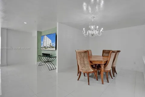 a dining room with furniture and chandelier