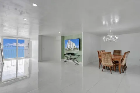 a view of a dining room with furniture and a chandelier