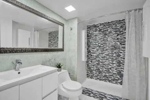 a bathroom with a glass shower door