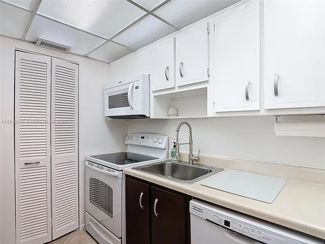 a kitchen with stainless steel appliances granite countertop a sink and a stove