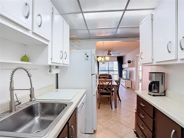 a kitchen with a sink cabinets and appliances