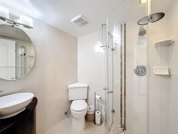 a bathroom with a toilet a sink and shower