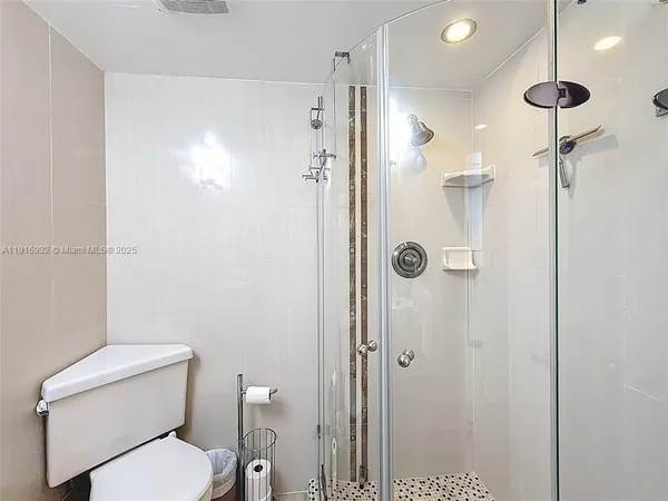 a bathroom with a toilet and a shower