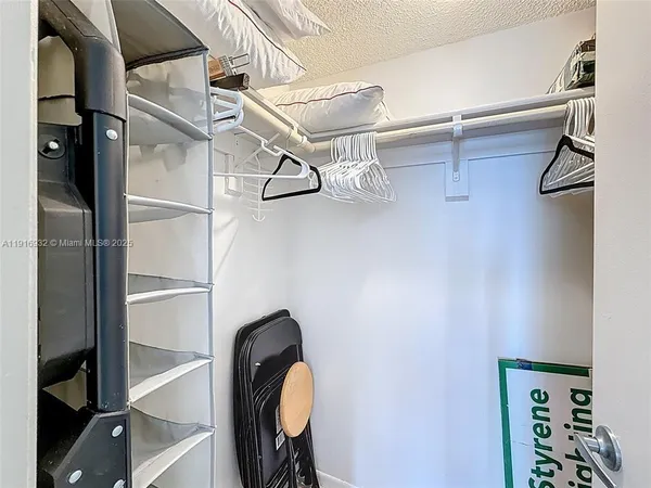 a view of walk in closet with empty racks