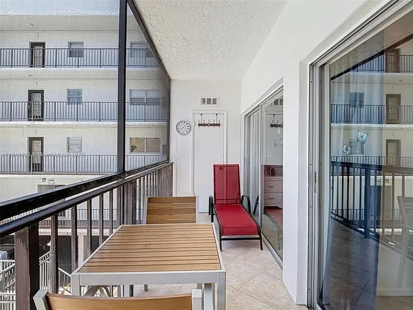 a view of a balcony with furniture