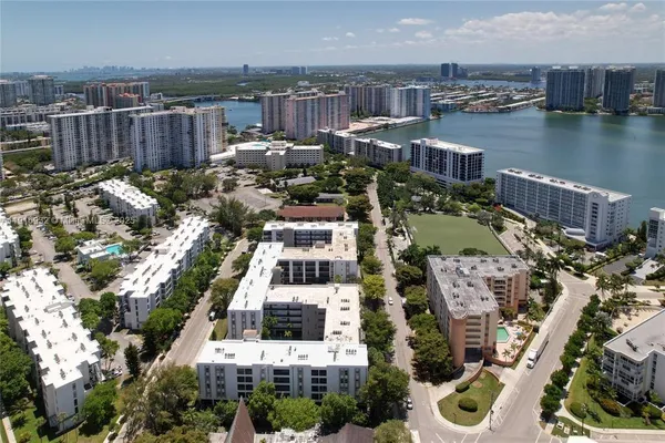 a view of a building with a yard and potted plants