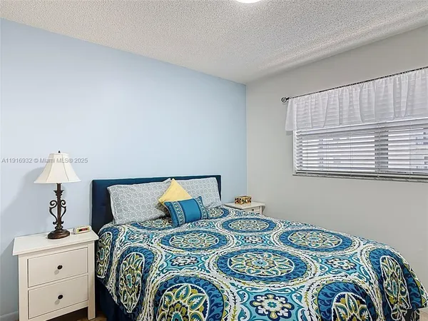 a bedroom with a bed and a table