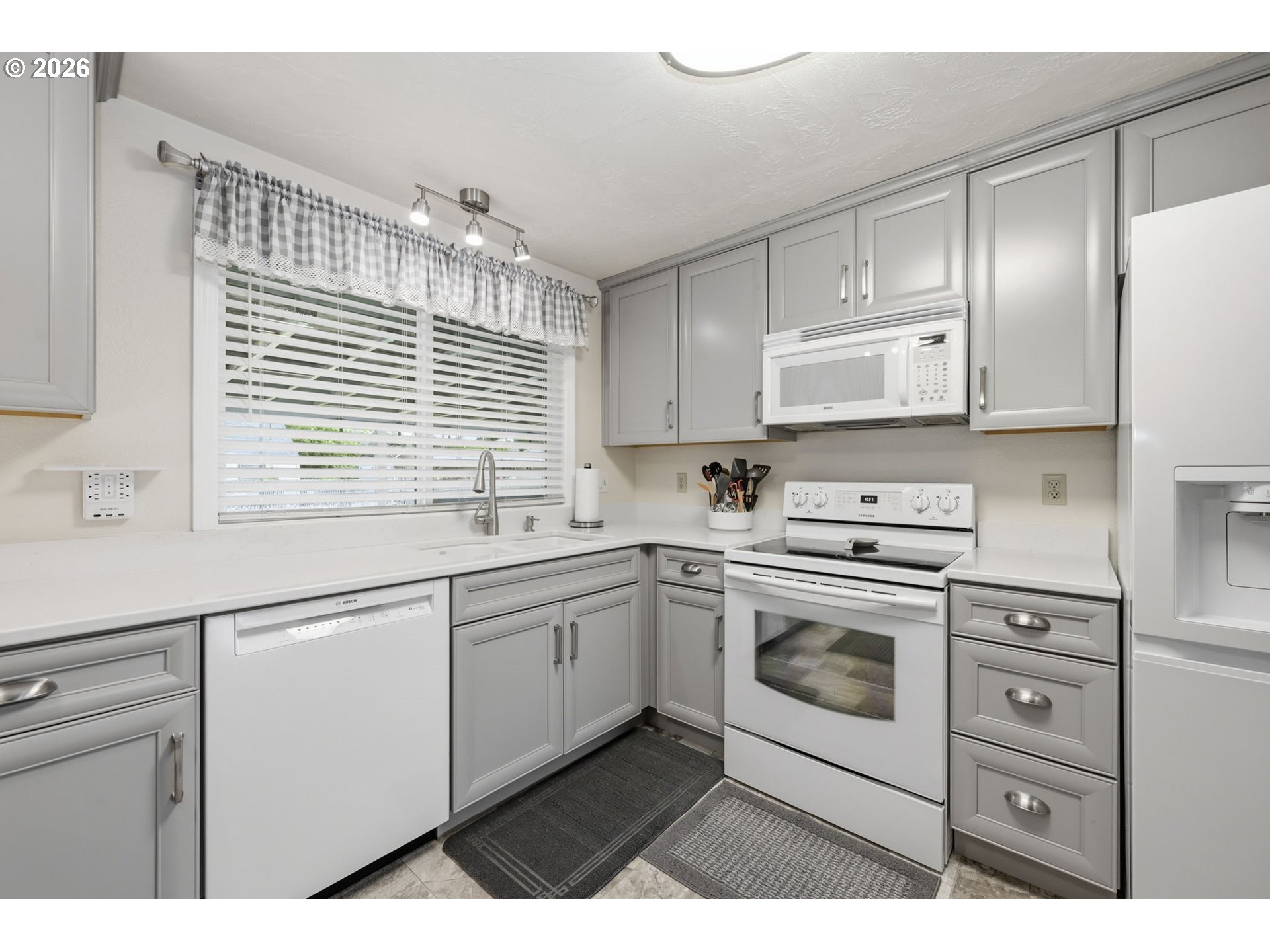 430 South 37th Place Springfield, OR 97478 - Photo 14 of 39 a kitchen with granite countertop white cabinets and white appliances