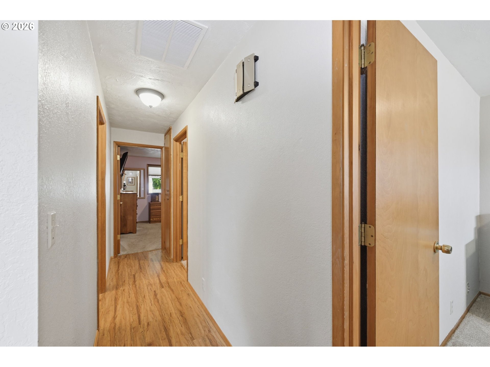 430 South 37th Place Springfield, OR 97478 - Photo 20 of 39 a hallway with wooden floor windows and a bathroom