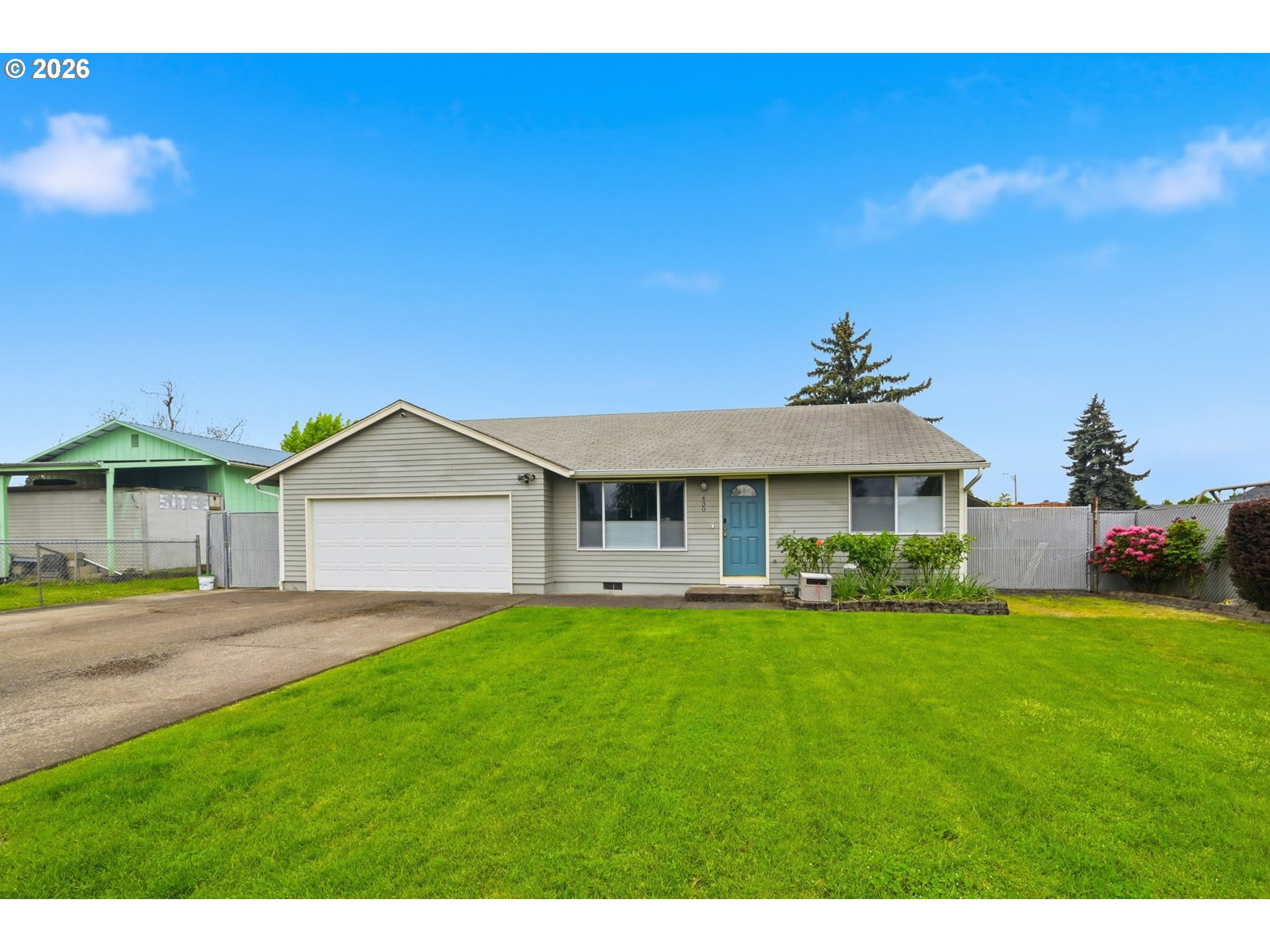 430 South 37th Place Springfield, OR 97478 - Photo 2 of 39 a front view of a house with a yard and garage