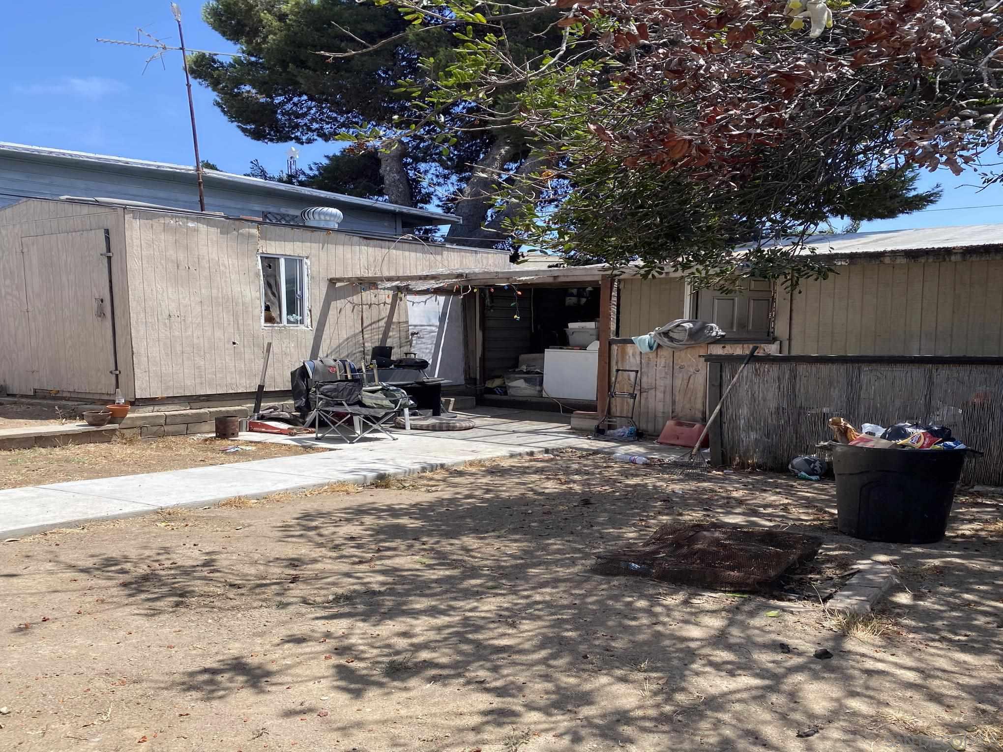 2743 Ridgeway Drive National City, CA 91950 - Photo 7 of 15 a view of a backyard with chair and tables