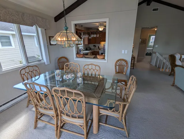 a kitchen with sink a window and chairs