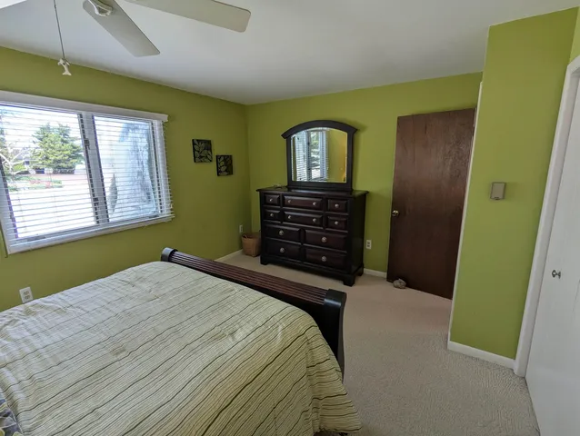 a bedroom with a bed and a chair