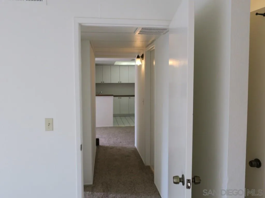 5938 Rancho Mission Road, Unit 134 San Diego, CA 92108 - Photo 23 of 36 a view of a hallway with a room
