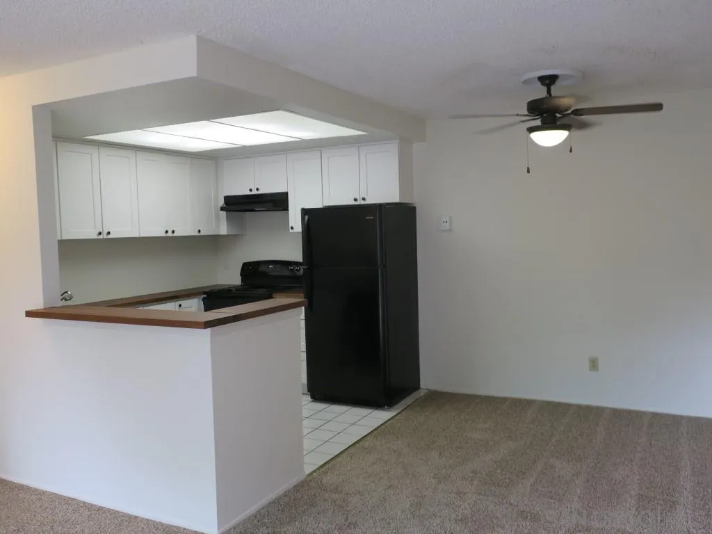 5938 Rancho Mission Road, Unit 134 San Diego, CA 92108 - Photo 7 of 36 a kitchen with a refrigerator and a stove