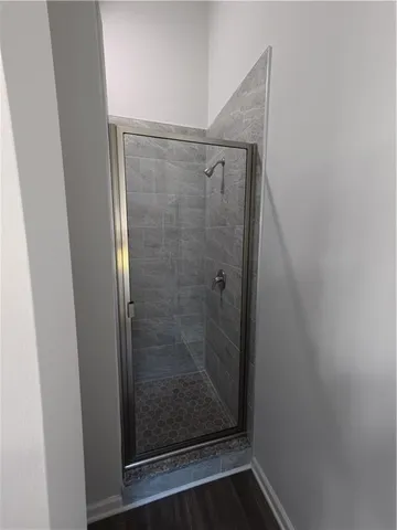 a bathroom with a glass shower door
