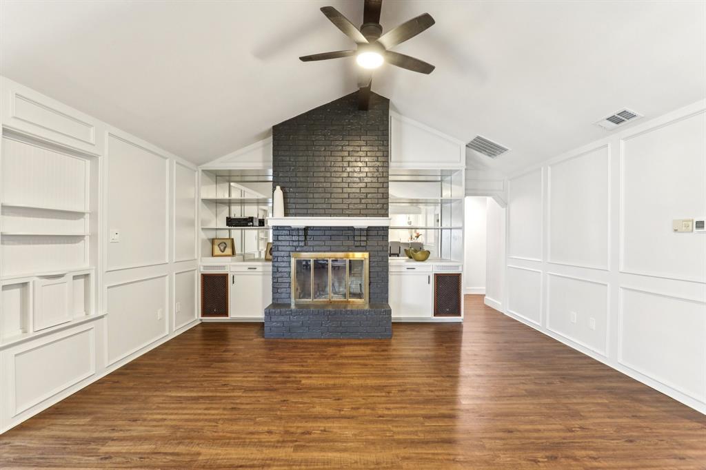 6667 Silver Saddle Road Fort Worth, TX 76126 - Photo 12 of 35 a living room with stainless steel appliances kitchen island granite countertop a stove and a refrigerator with wooden floors
