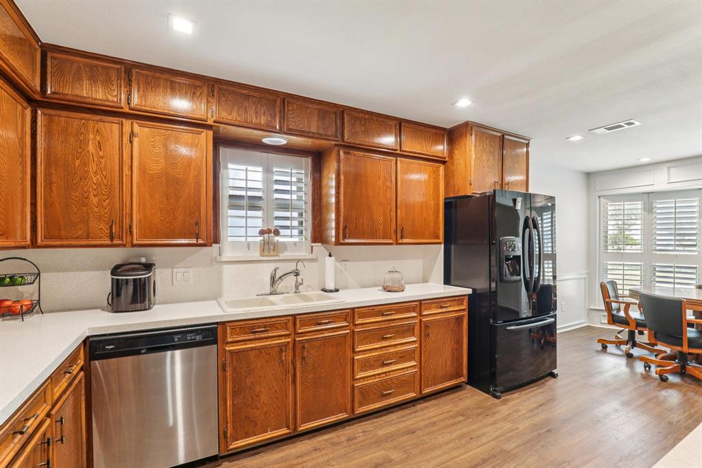6667 Silver Saddle Road Fort Worth, TX 76126 - Photo 16 of 35 a kitchen with stainless steel appliances a refrigerator sink and cabinets