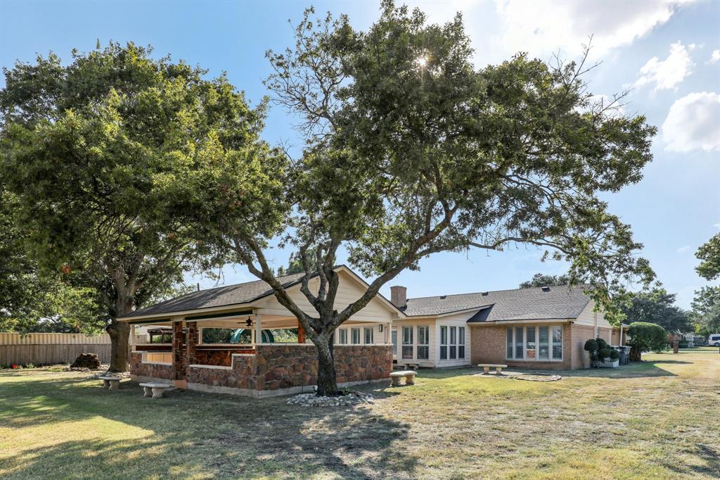 6667 Silver Saddle Road Fort Worth, TX 76126 - Photo 30 of 35 a front view of a house with a yard table and chairs