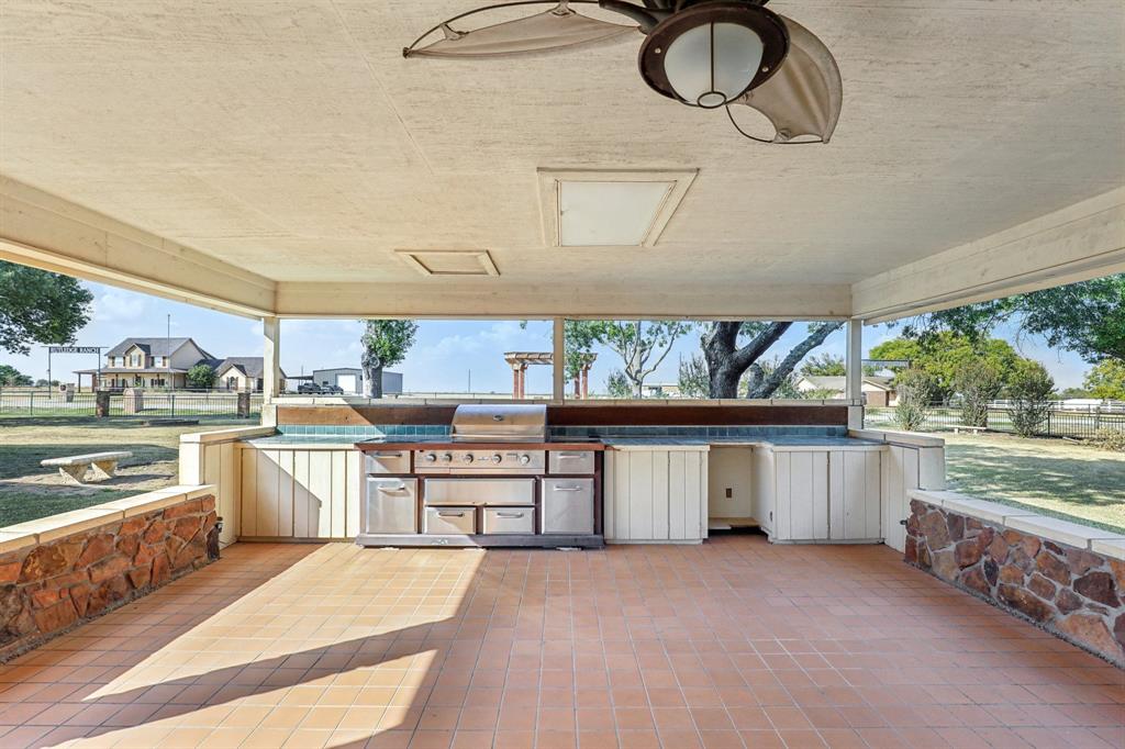 6667 Silver Saddle Road Fort Worth, TX 76126 - Photo 32 of 35 a kitchen with stainless steel appliances granite countertop a stove a sink and a microwave