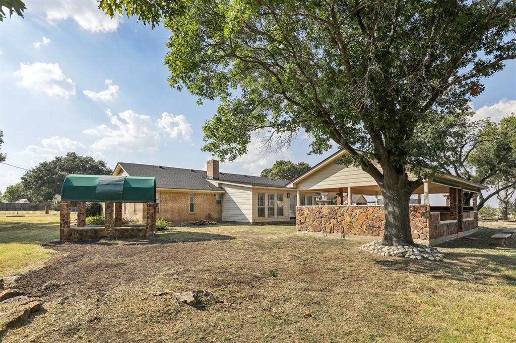6667 Silver Saddle Road Fort Worth, TX 76126 - Photo 33 of 35 a front view of a house with a garden