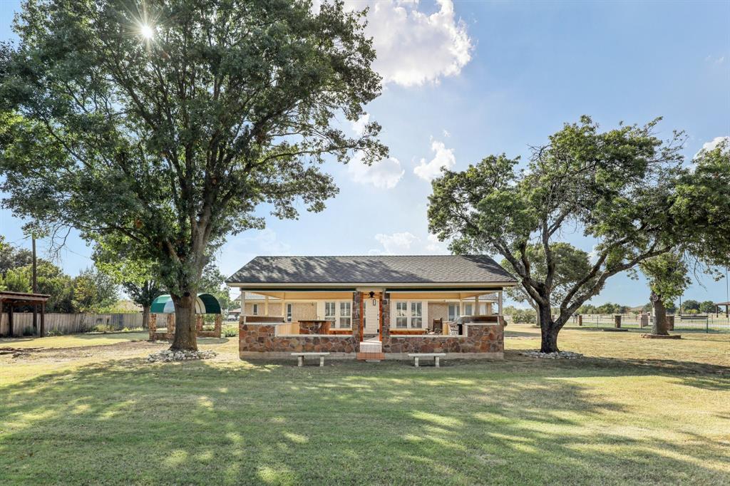 6667 Silver Saddle Road Fort Worth, TX 76126 - Photo 34 of 35 a view of a house with garden and trees