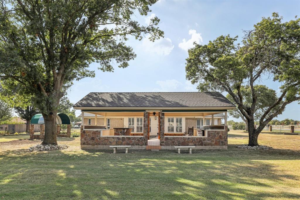 6667 Silver Saddle Road Fort Worth, TX 76126 - Photo 35 of 35 a front view of a house with a garden