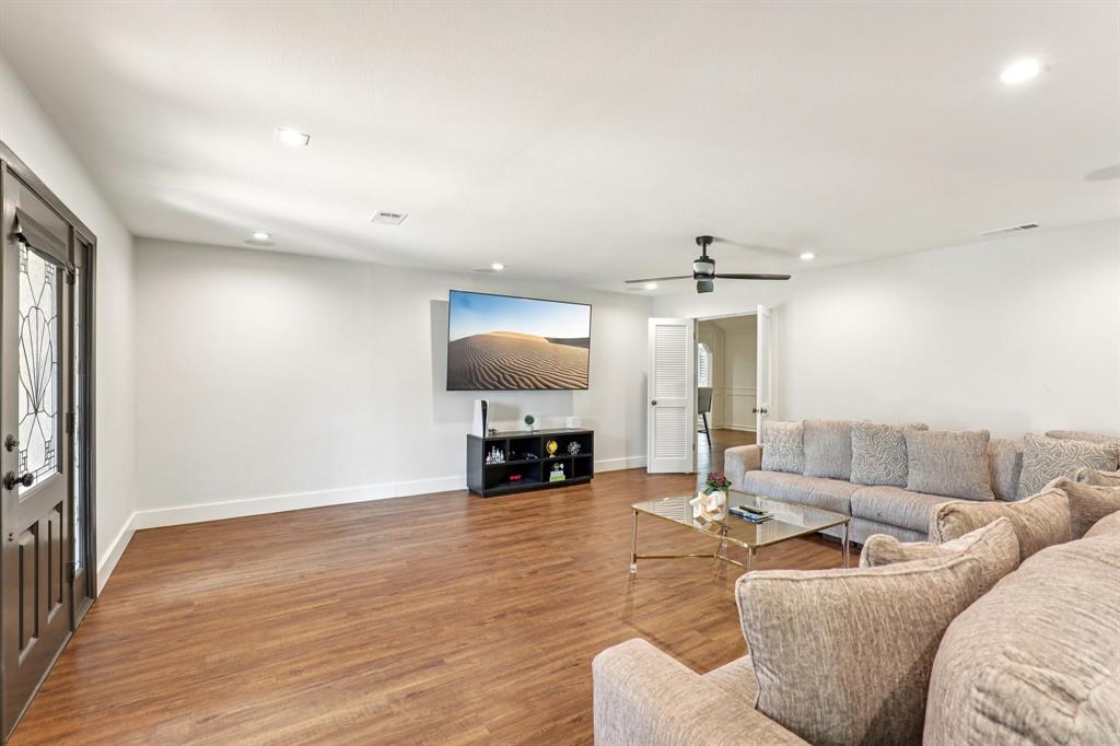 6667 Silver Saddle Road Fort Worth, TX 76126 - Photo 7 of 35 a living room with furniture and a flat screen tv