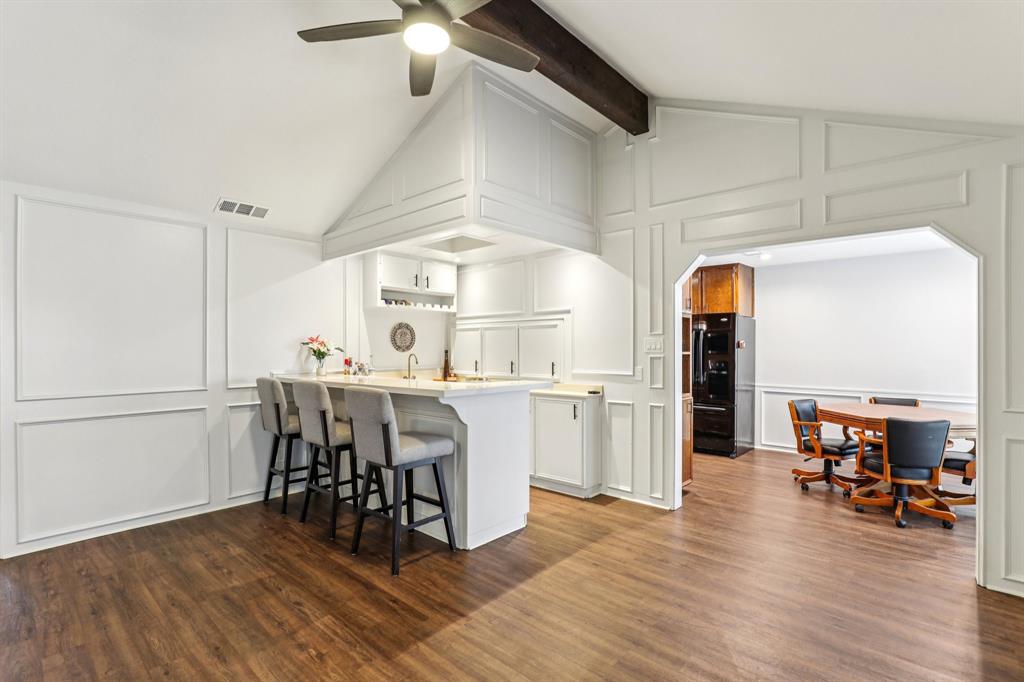 6667 Silver Saddle Road Fort Worth, TX 76126 - Photo 9 of 35 a kitchen with stainless steel appliances a dining table chairs stove and cabinets