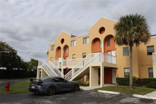 a front view of a house with outdoor space and parking