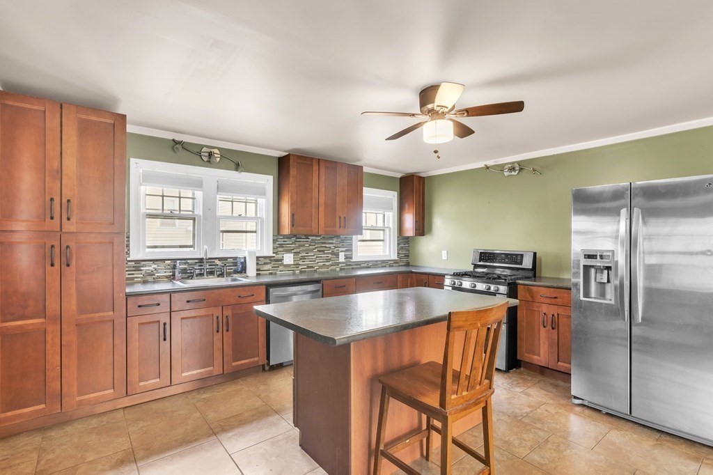 61 Beauregard Street Springfield, MA 01151 - Photo 2 of 24 a kitchen with stainless steel appliances granite countertop a sink a stove and a refrigerator