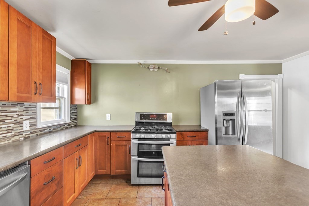 61 Beauregard Street Springfield, MA 01151 - Photo 8 of 24 a kitchen with stainless steel appliances a refrigerator and a stove