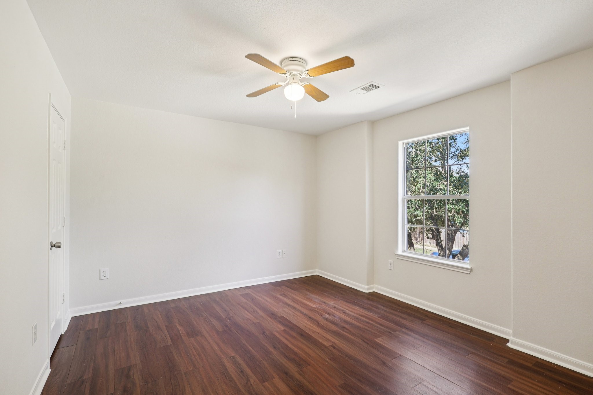 4822 East Fairfax Village Circle Spring, TX 77373 - Photo 16 of 24 an empty room with wooden floor ceiling fan and windows