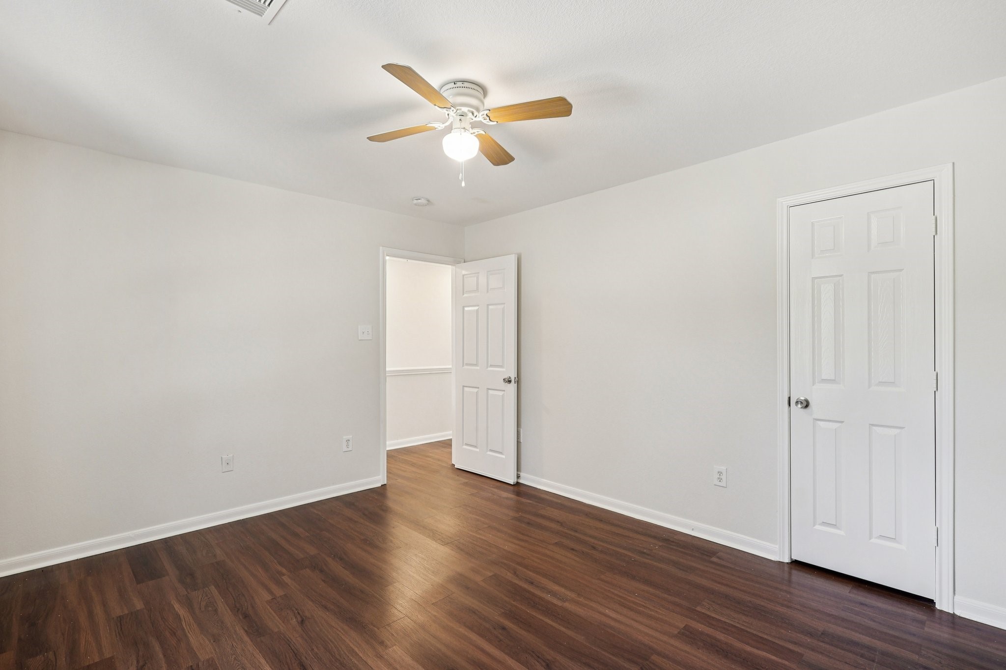 4822 East Fairfax Village Circle Spring, TX 77373 - Photo 17 of 24 an empty room with wooden floor fan and windows