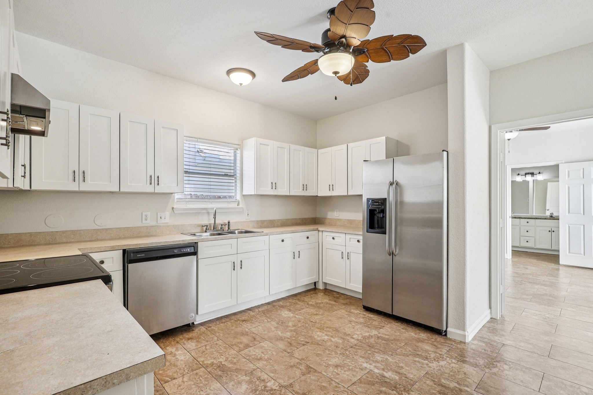 4822 East Fairfax Village Circle Spring, TX 77373 - Photo 7 of 24 a kitchen with stainless steel appliances granite countertop a sink a stove a refrigerator a microwave oven with white cabinets