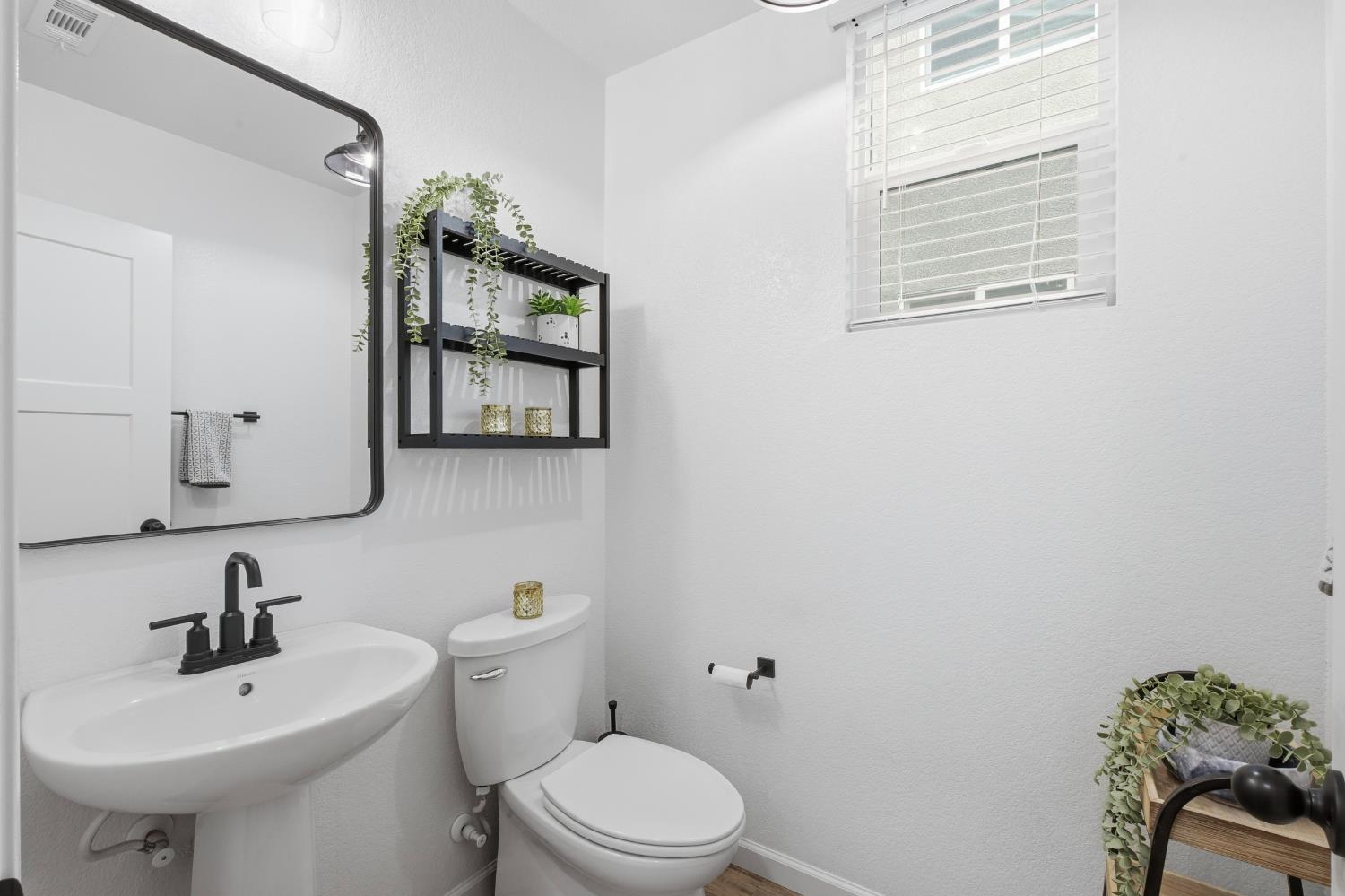 7240 Encore Way Roseville, CA 95747 - Photo 12 of 52 a bathroom with a toilet sink and mirror