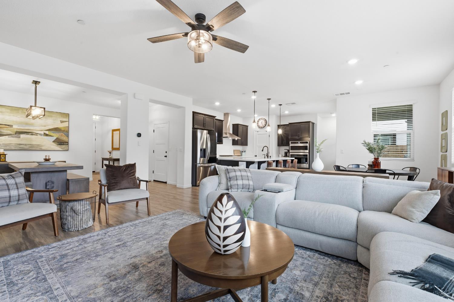 7240 Encore Way Roseville, CA 95747 - Photo 19 of 52 a living room with furniture kitchen view and a dining table
