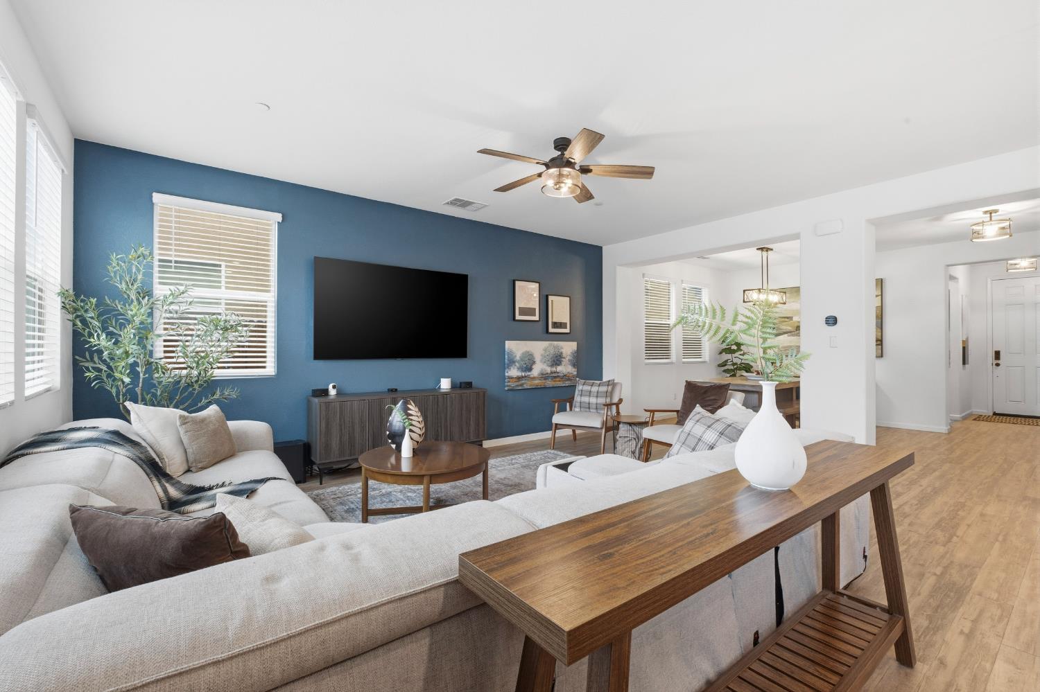 7240 Encore Way Roseville, CA 95747 - Photo 20 of 52 a living room with furniture a flat screen tv and a large window