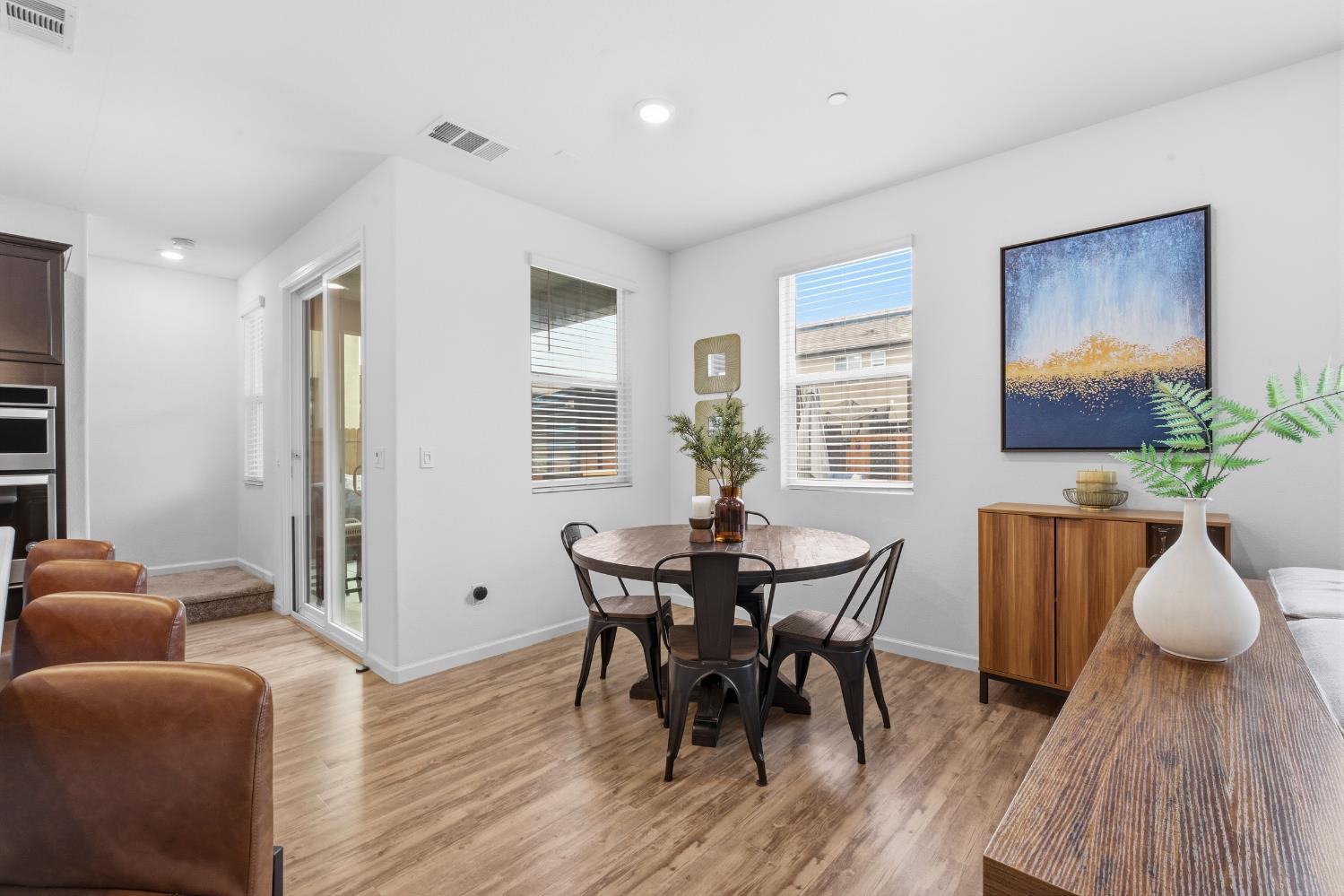 7240 Encore Way Roseville, CA 95747 - Photo 22 of 52 a view of a dining room with furniture and wooden floor