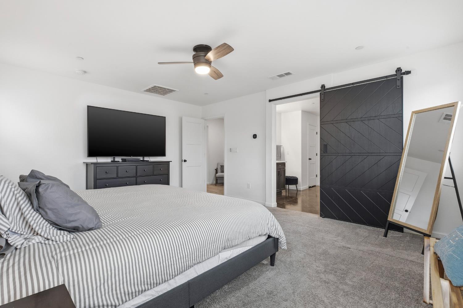 7240 Encore Way Roseville, CA 95747 - Photo 28 of 52 a bedroom with a bed and a flat tv screen on wall