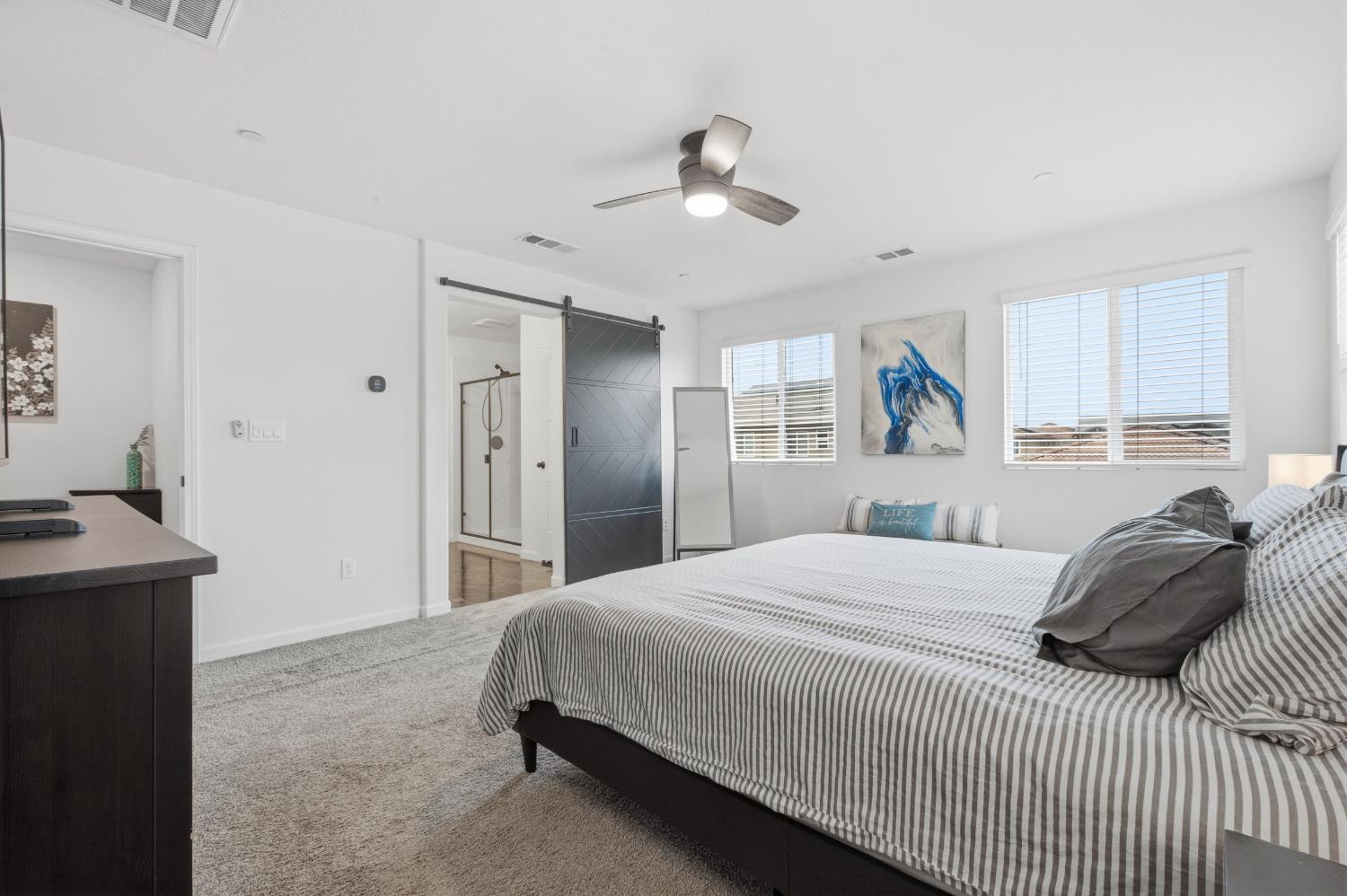 7240 Encore Way Roseville, CA 95747 - Photo 29 of 52 a bedroom with a bed and a chandelier