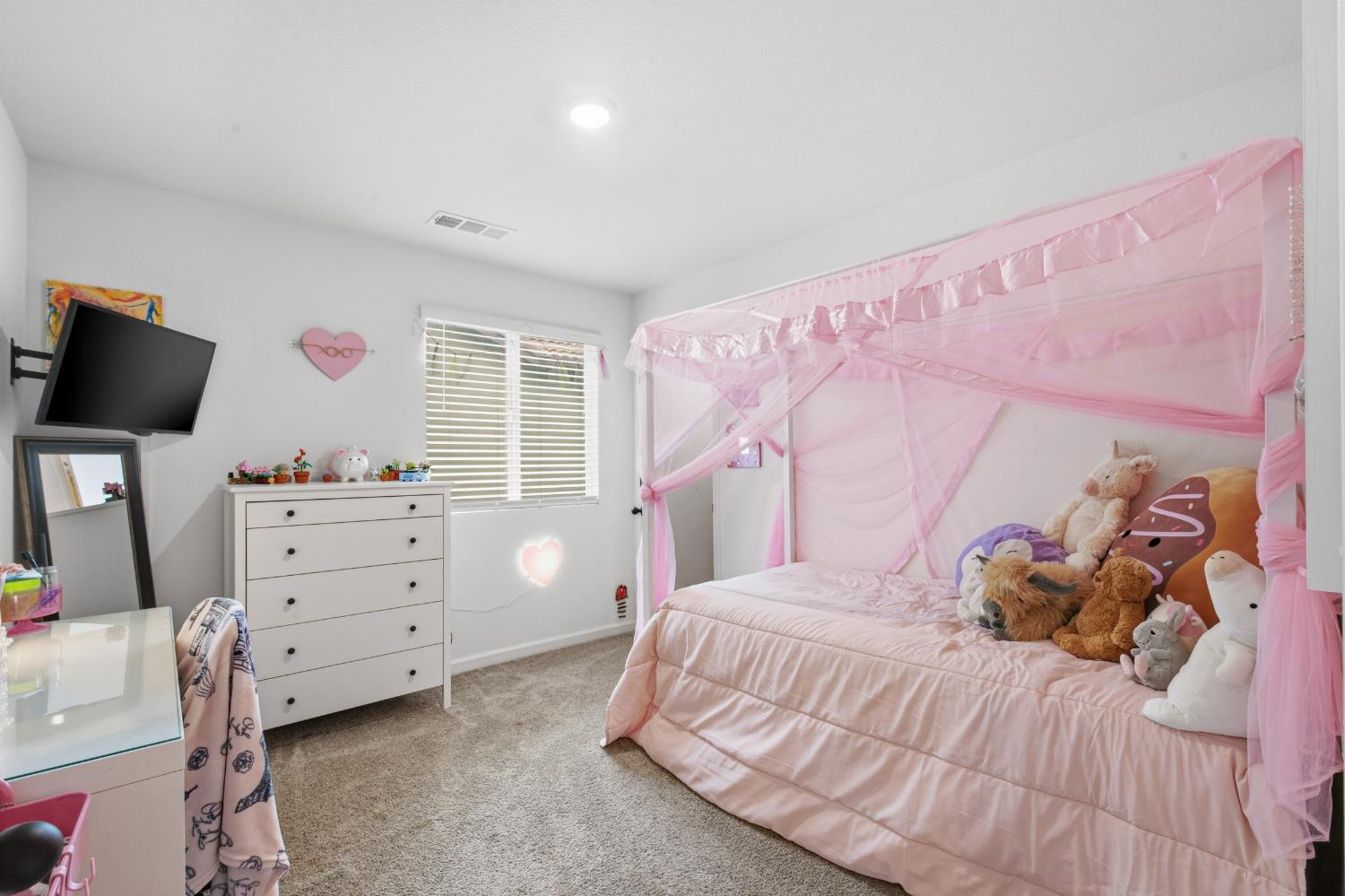 7240 Encore Way Roseville, CA 95747 - Photo 35 of 52 a bedroom with a bed and a flat tv screen on dresser