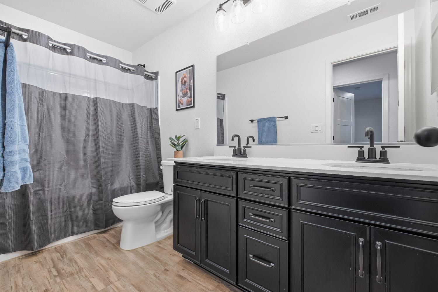7240 Encore Way Roseville, CA 95747 - Photo 38 of 52 a bathroom with a sink toilet and shower