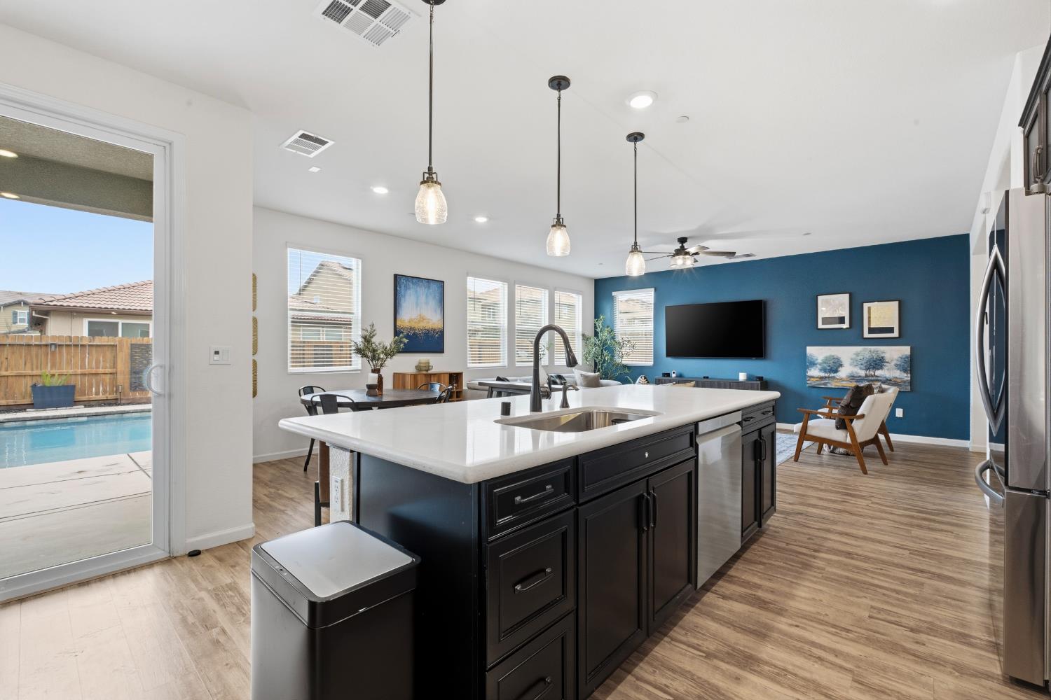 7240 Encore Way Roseville, CA 95747 - Photo 7 of 52 a large kitchen with kitchen island a sink appliances and a counter space