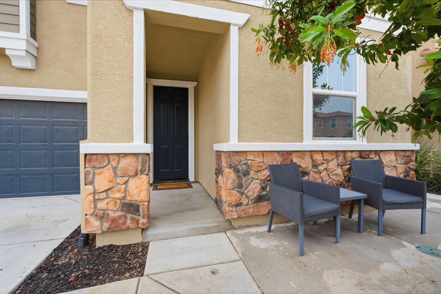 7240 Encore Way Roseville, CA 95747 - Photo 10 of 52 a porch with a bench and a potted plant