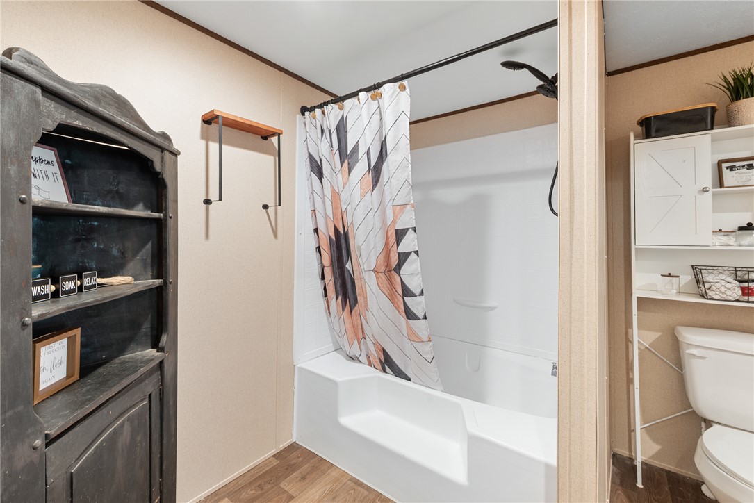 309 Tanglewood Lane Somerville, TX 77879 - Photo 12 of 21 a bathroom with a shower curtain and a sink