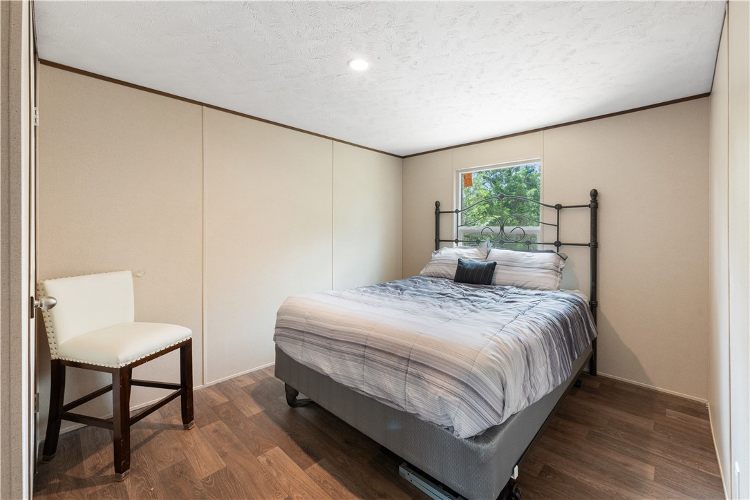 309 Tanglewood Lane Somerville, TX 77879 - Photo 15 of 21 a bedroom with a bed table and chair