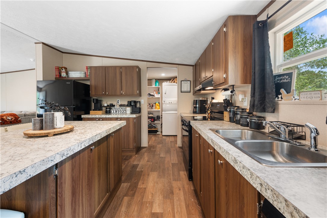309 Tanglewood Lane Somerville, TX 77879 - Photo 6 of 21 a kitchen with kitchen island granite countertop a sink stove and cabinets
