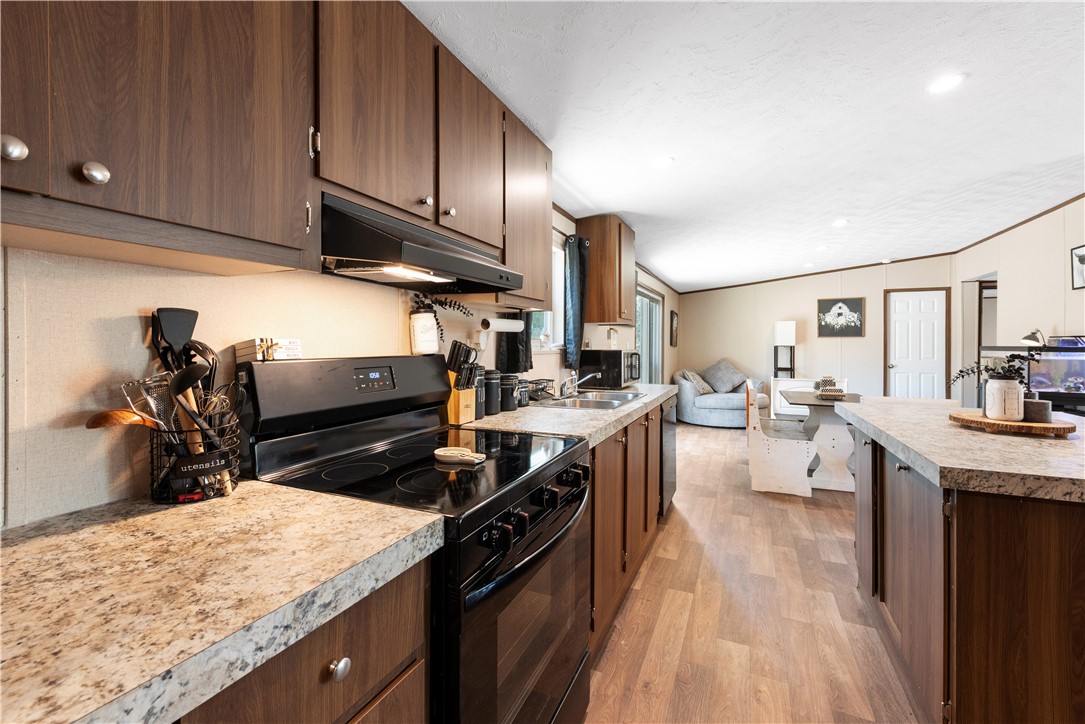 309 Tanglewood Lane Somerville, TX 77879 - Photo 7 of 21 a kitchen with stove a sink and cabinets